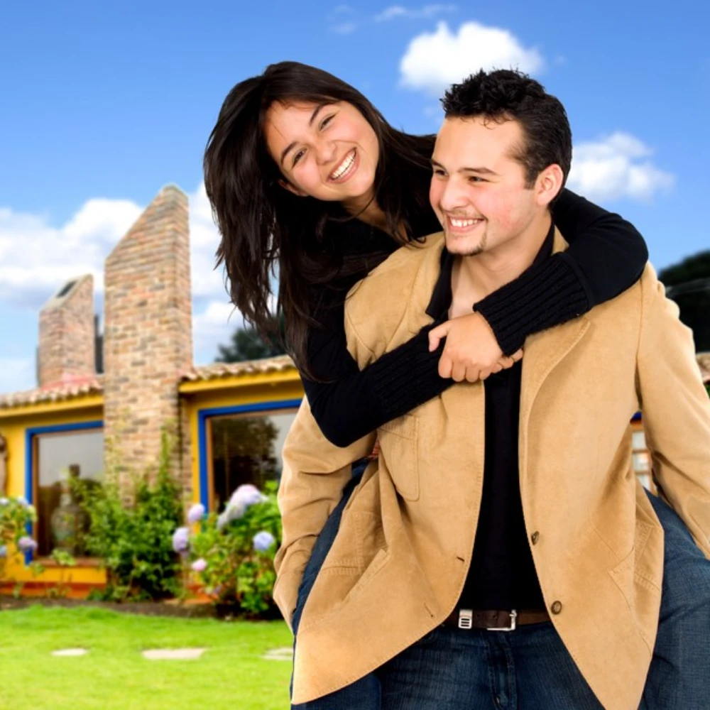 Happy couple in front of their new home